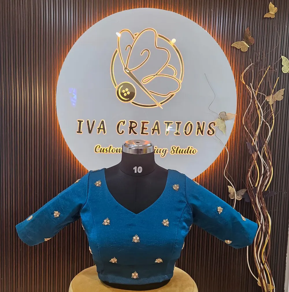 Teal blue blouse with scattered bead and stone motifs