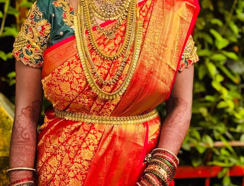 Red Kanchipuram saree with a green zardosi embroidered blouse