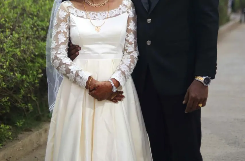 Ivory satin wedding gown with floral lace sleeves and neckline
