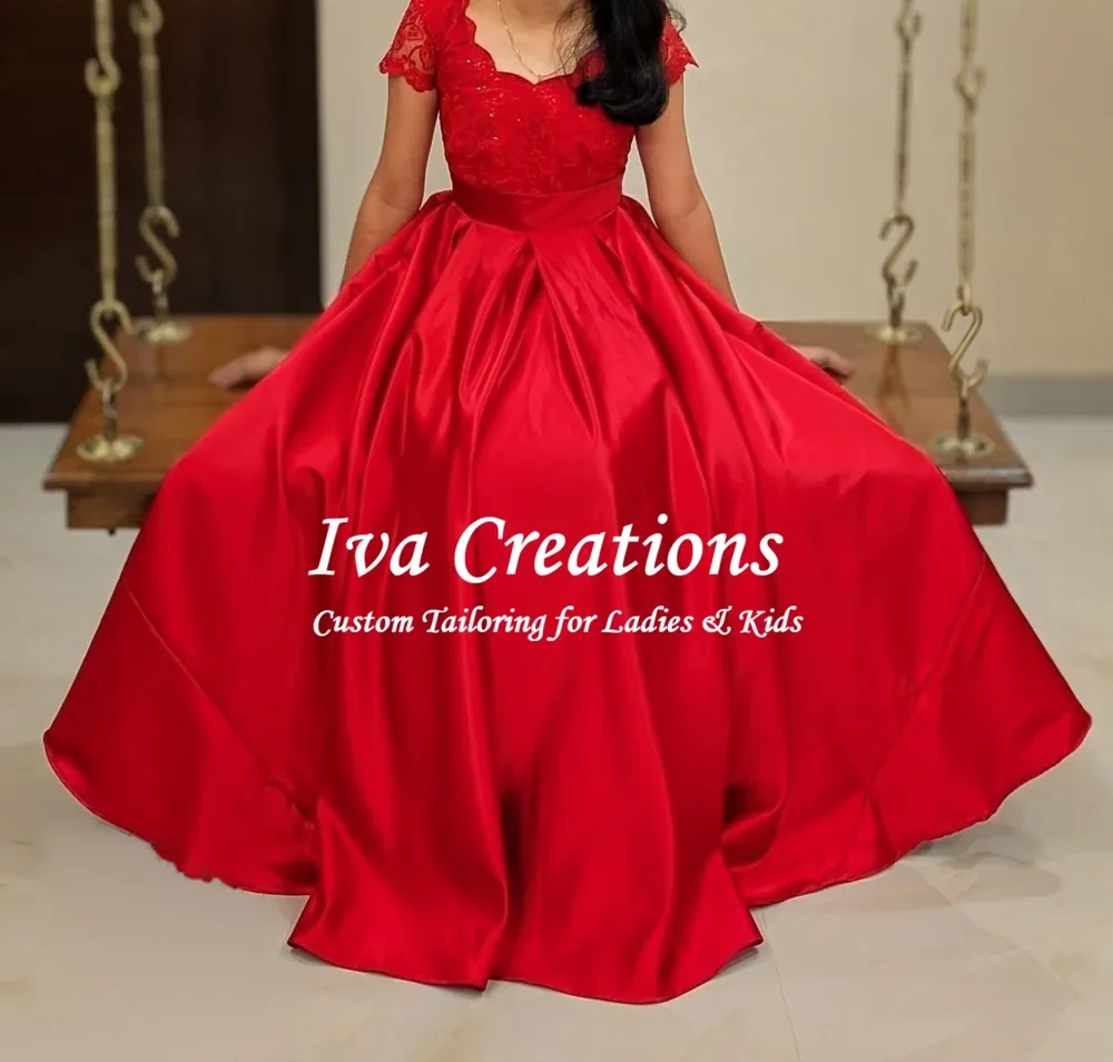 Red satin ball gown with a scalloped lace bodice, stitched by Iva Creations