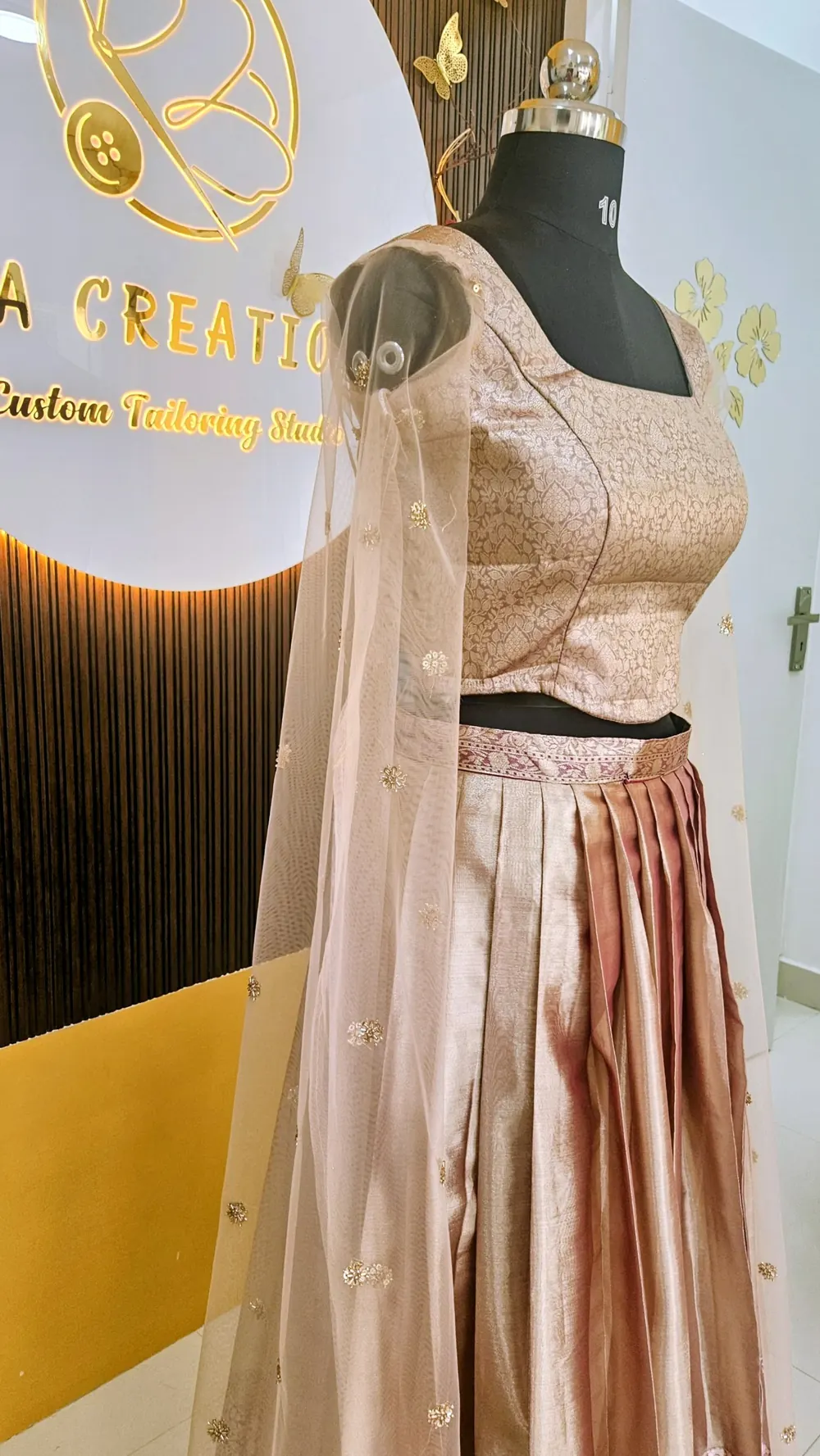 Brocade crop top and tissue skirt with an embroidered net cape sleeve